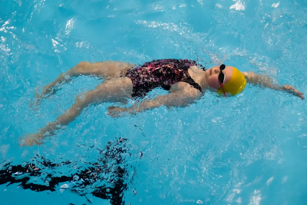 A child practicing her backstroke