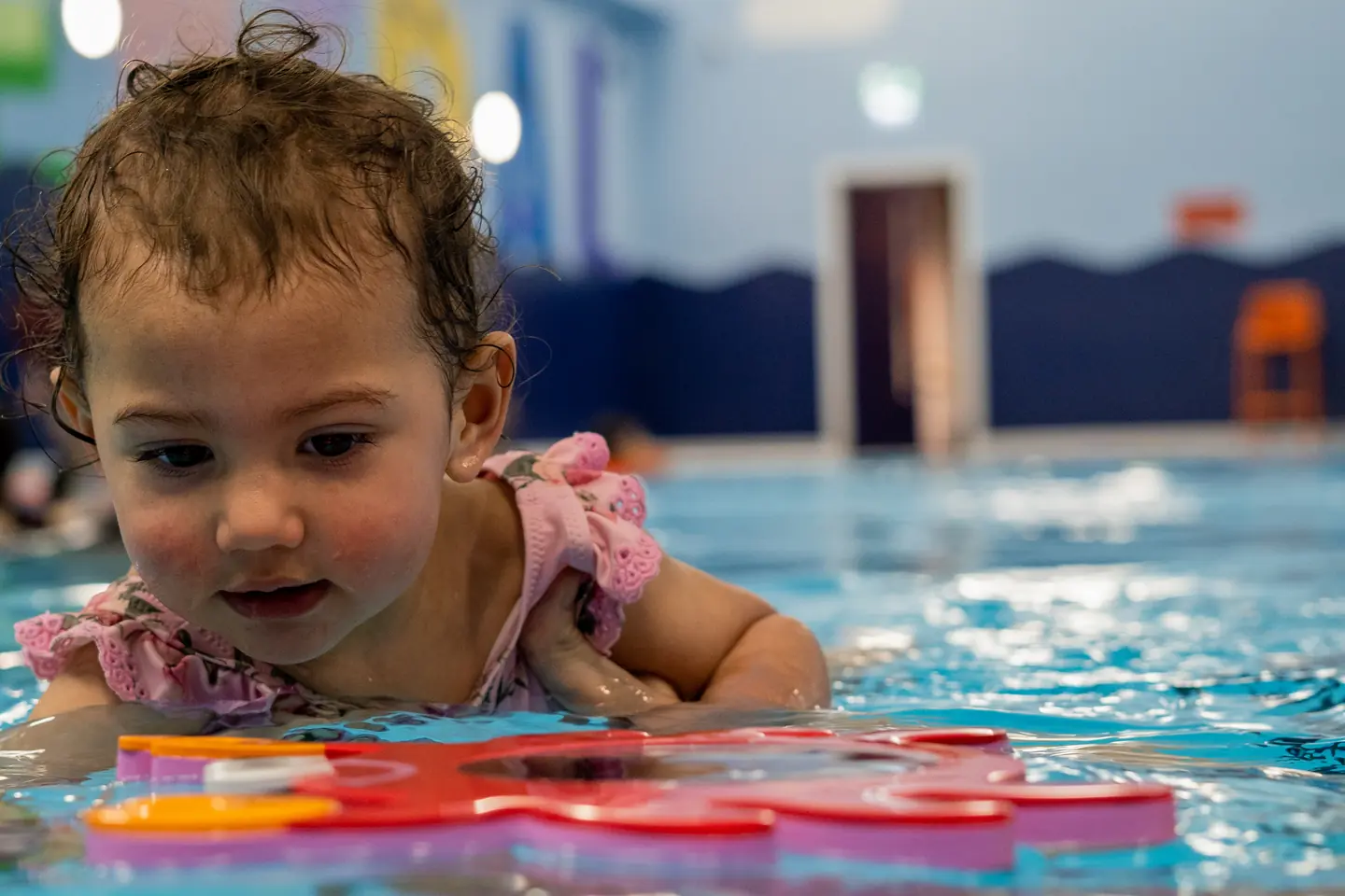 A cute baby playing in the pool