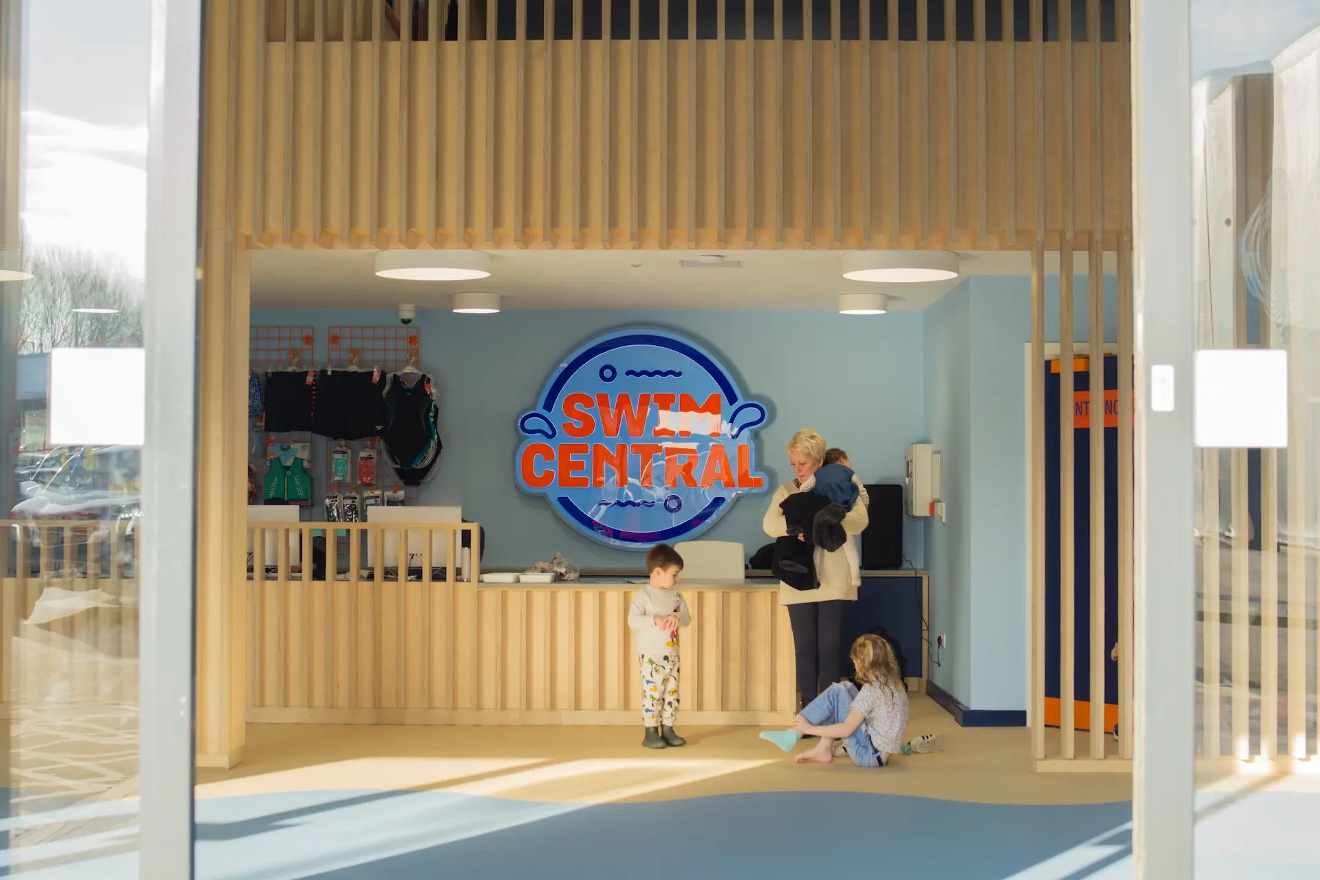 A grandma with her three grandchildren playing in the reception at Swim Central, Preston