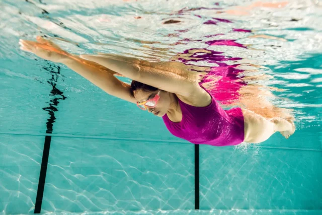 Woman swimming in a pool underwater