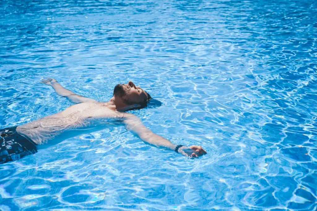 Young man floating in pool