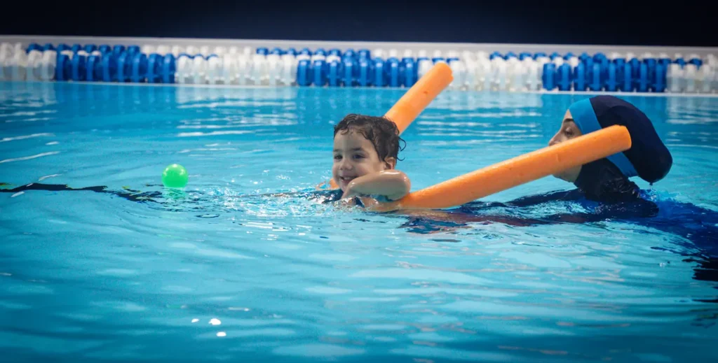 Baby floating in the water using float